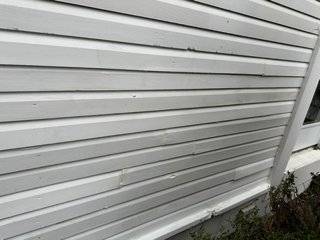 Close up of cracked vinyl siding on a piqua ohio home
