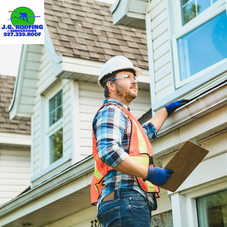 Roofing contractor performing roof inspection in kettering ohio